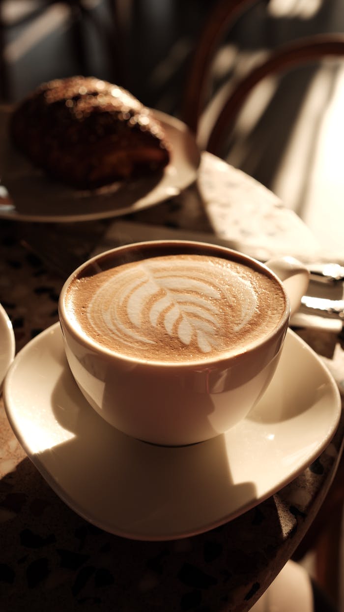 Enjoy a warm café latte with artistic foam in a cozy Gaziantep café.